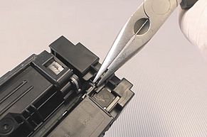 Carefully remove the holding clamp of the HP 201 cartridge chip