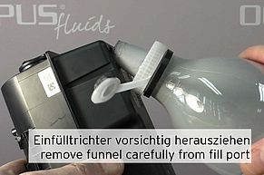 Remove funnel from fill port carefully